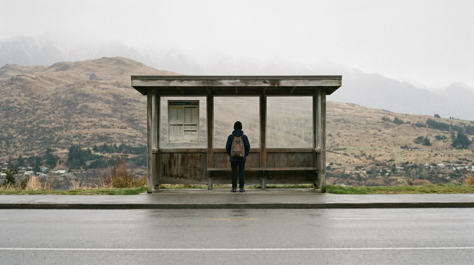 An Orbus bus on the lakefront road below the Remarkables, the everyday way of getting around Queenstown, New Zealand