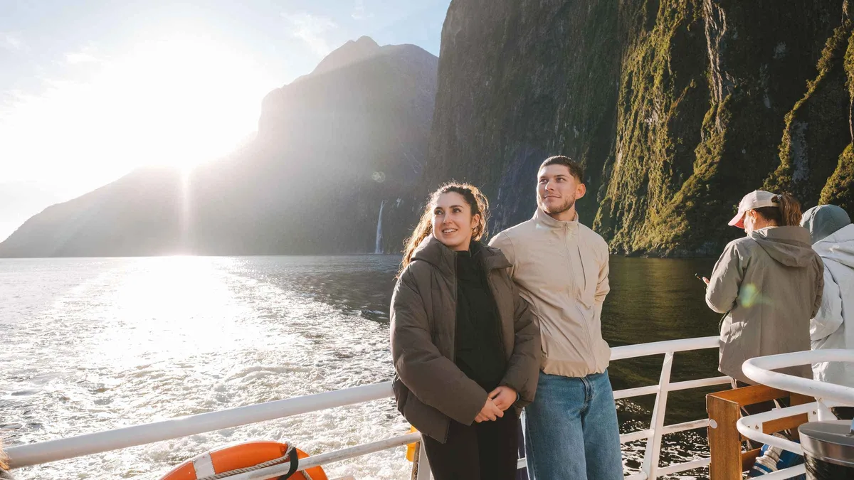 A small-group touring van beside the fiord at Milford Sound — Milford Sound day trip from Queenstown, New Zealand