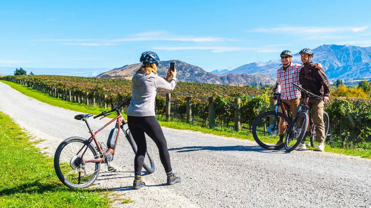 Cyclists on the river trail between Gibbston Valley wineries — Gibbston Valley wine tour, Queenstown, New Zealand