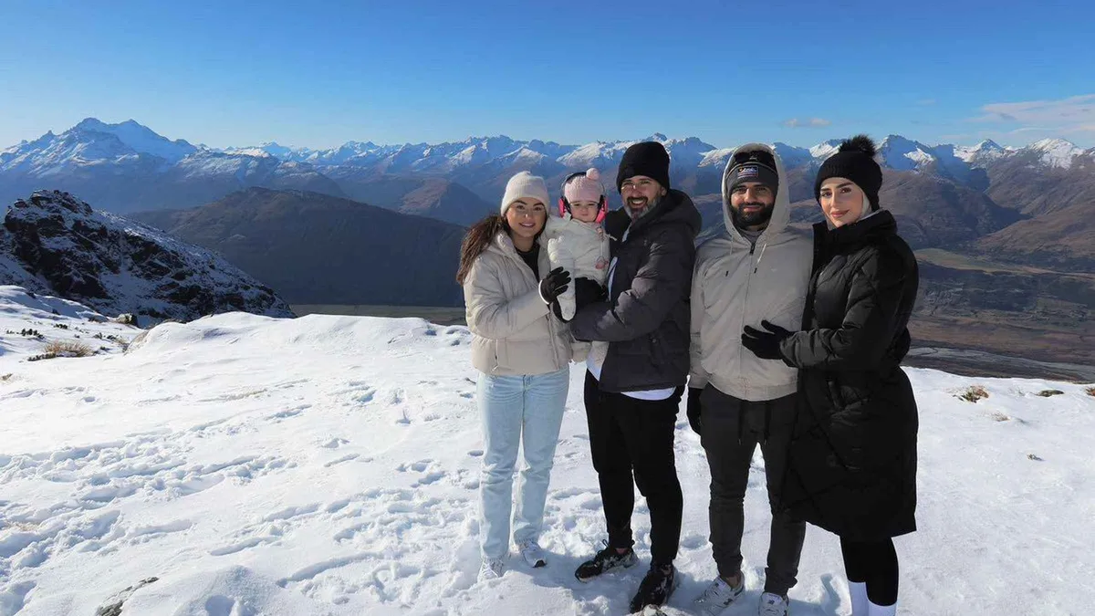 Passengers stepping onto snow at an alpine helicopter landing — Queenstown tours, New Zealand