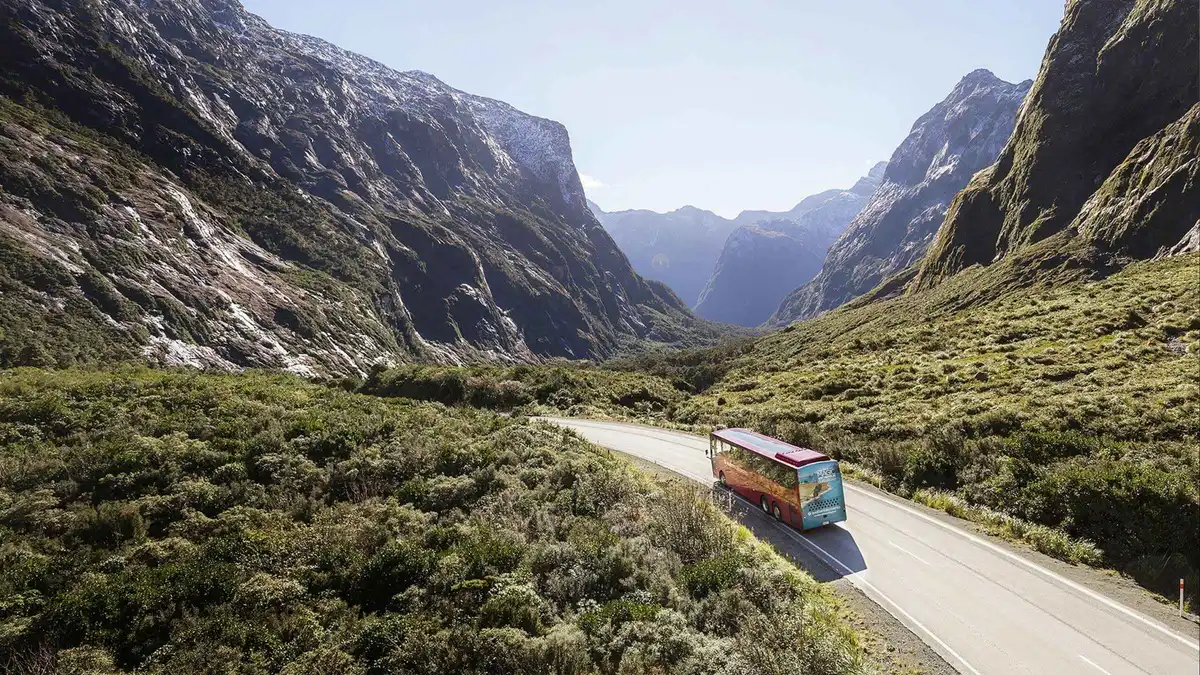 A scenic flight climbing over Fiordland peaks after the cruise — Milford Sound day trip from Queenstown, New Zealand